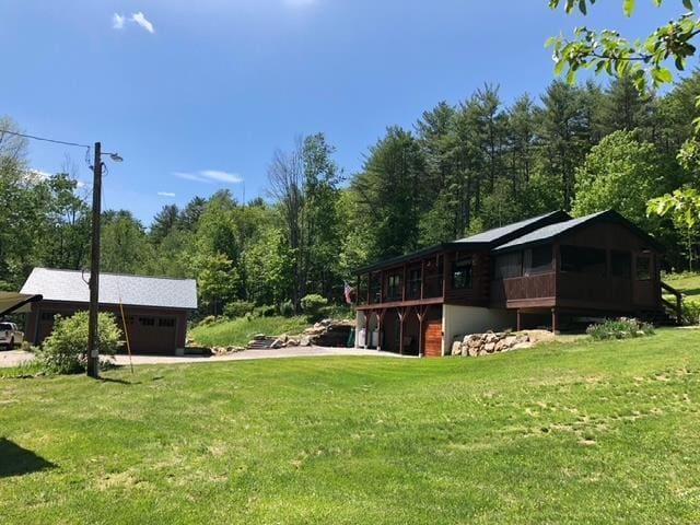 view of yard featuring a garage and a carport