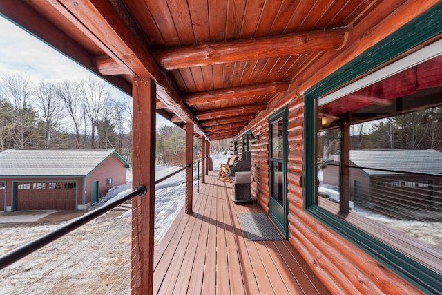 snow covered deck with an outbuilding