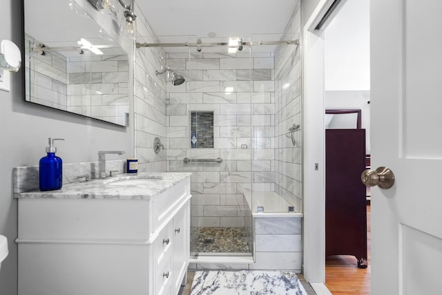 bathroom featuring a shower stall and vanity