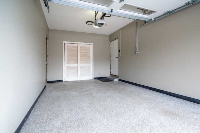 garage featuring a garage door opener and baseboards