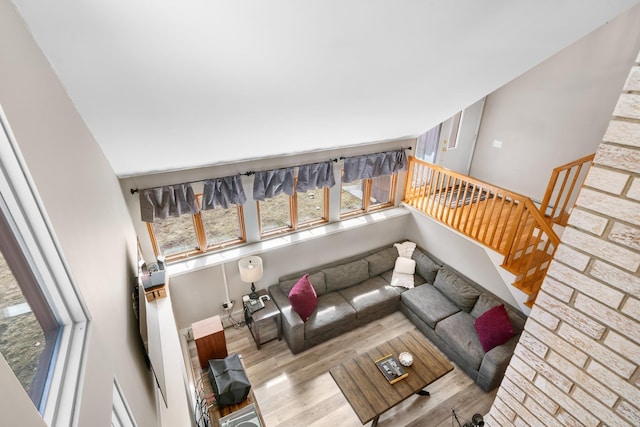 living area with stairs and wood finished floors