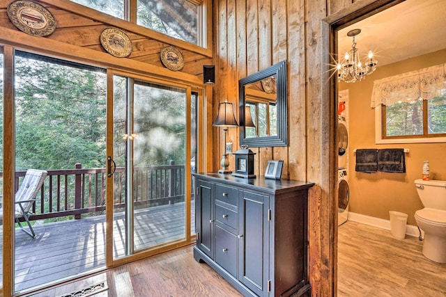 entryway featuring a wealth of natural light, a notable chandelier, and wood finished floors