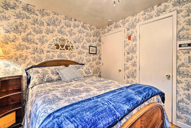 bedroom with wallpapered walls