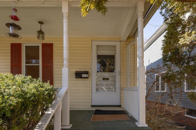 view of exterior entry featuring a porch