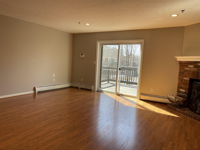 unfurnished living room featuring baseboards, recessed lighting, a fireplace, wood finished floors, and a baseboard radiator