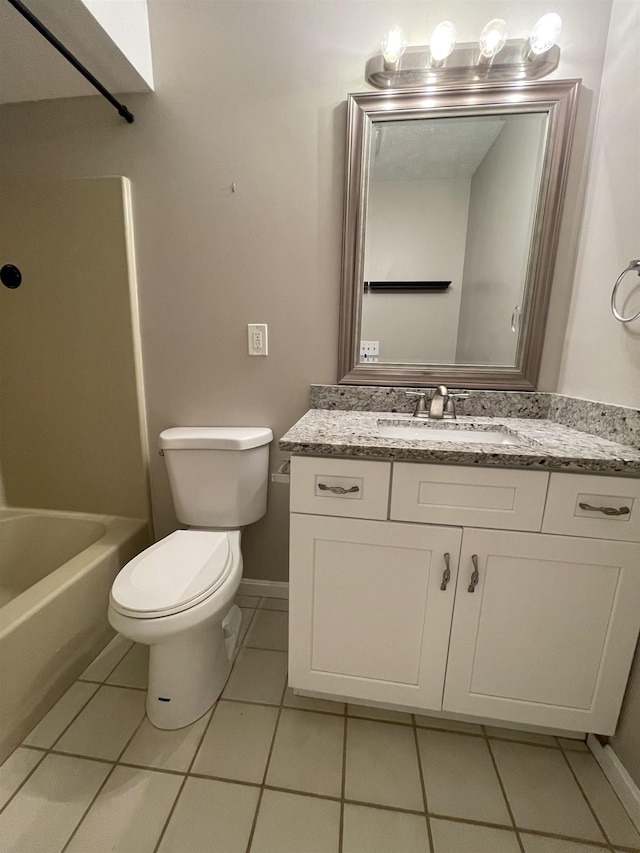 full bath featuring tile patterned floors, toilet, vanity, and baseboards