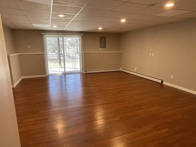 unfurnished room featuring recessed lighting, a drop ceiling, baseboards, and dark wood-style flooring