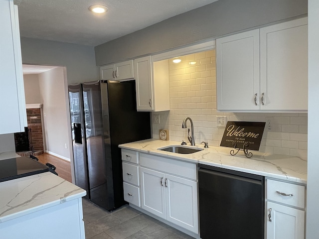 kitchen featuring a sink, tasteful backsplash, white cabinets, stainless steel fridge with ice dispenser, and dishwashing machine