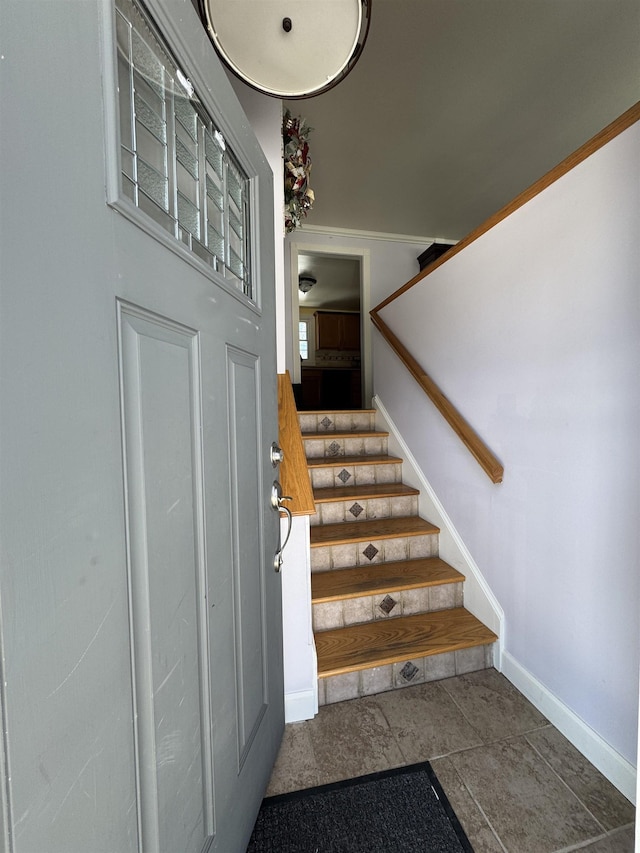 stairway featuring baseboards