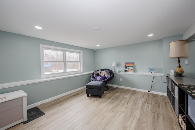 sitting room featuring recessed lighting, baseboards, and light wood-type flooring