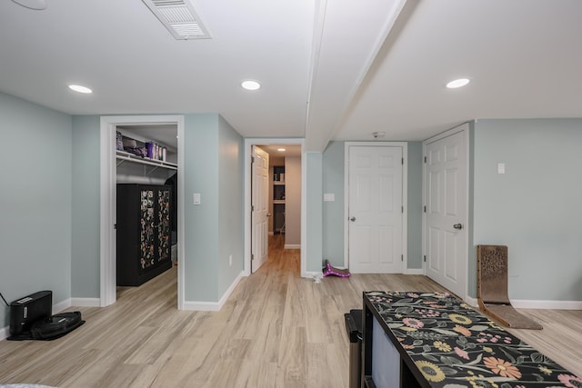 interior space with recessed lighting, light wood-style floors, visible vents, and baseboards