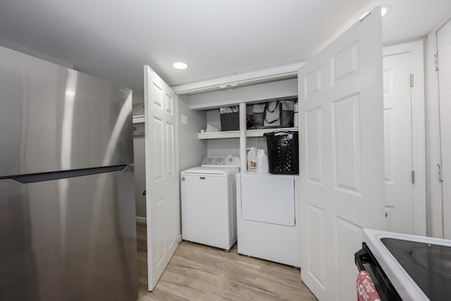 clothes washing area with recessed lighting, laundry area, and light wood-style flooring