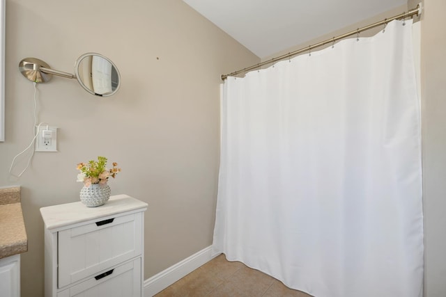 full bathroom featuring tile patterned flooring, vanity, and baseboards