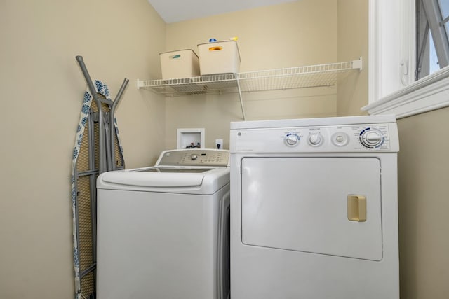 laundry room with separate washer and dryer and laundry area