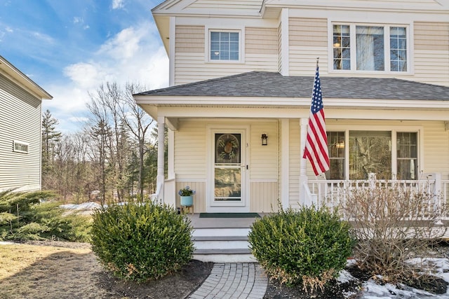 property entrance with a porch and a shingled roof