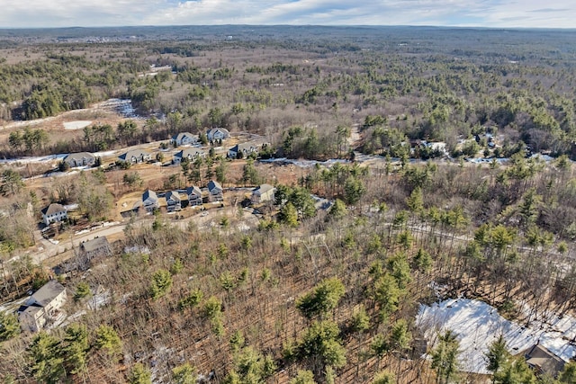 drone / aerial view with a wooded view