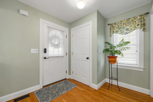 entrance foyer featuring visible vents, baseboards, and light wood finished floors