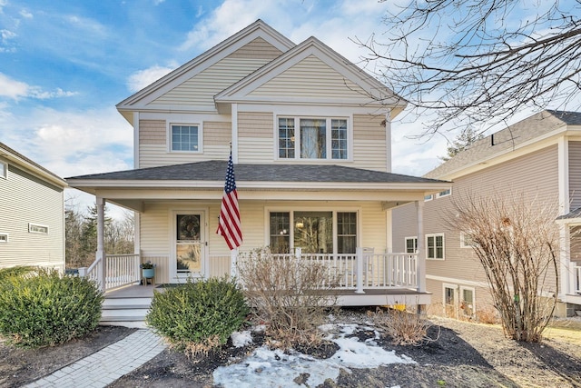 view of front of property featuring a porch and a shingled roof