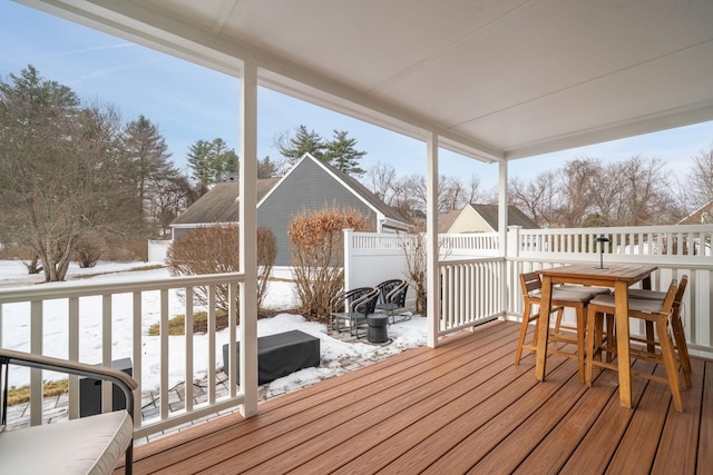 snow covered deck featuring outdoor dining space