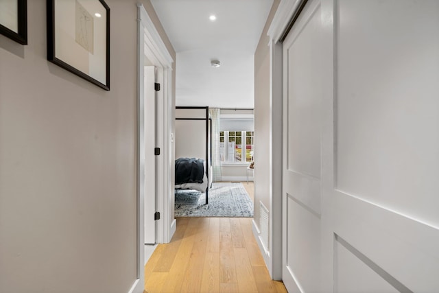 hallway with recessed lighting, baseboards, and light wood-style floors