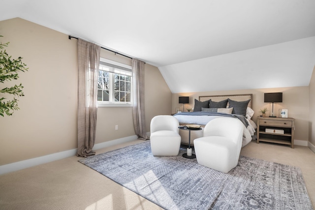 carpeted bedroom with baseboards and lofted ceiling