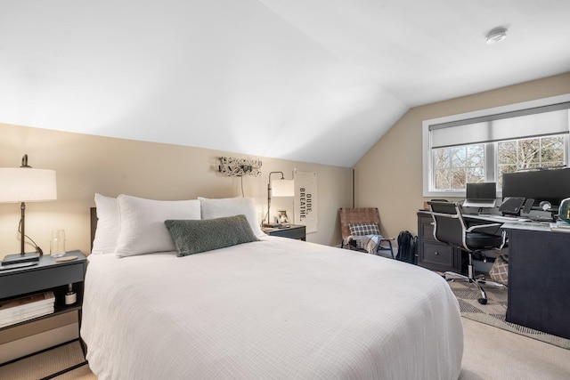 bedroom featuring vaulted ceiling and light carpet