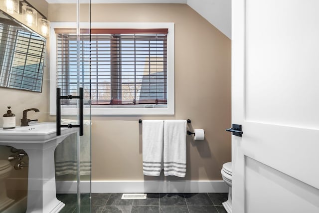 bathroom with toilet and baseboards