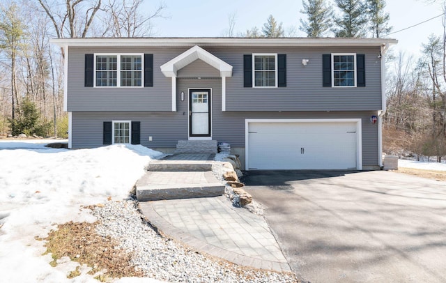 split foyer home featuring a garage and driveway