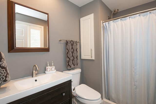 bathroom with vanity, a shower with shower curtain, and toilet