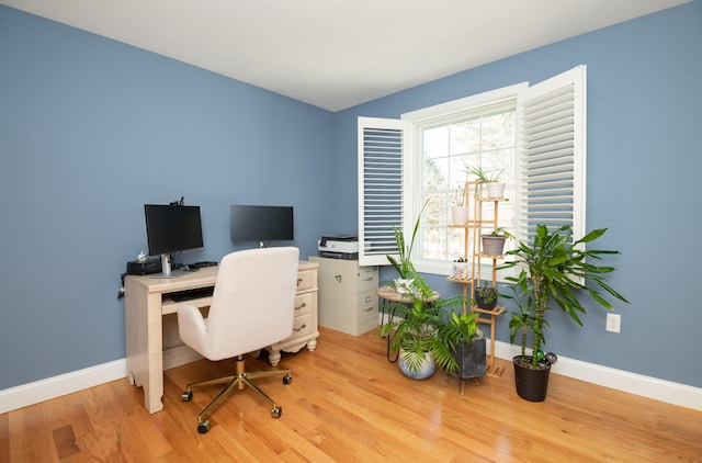 home office featuring baseboards and wood finished floors