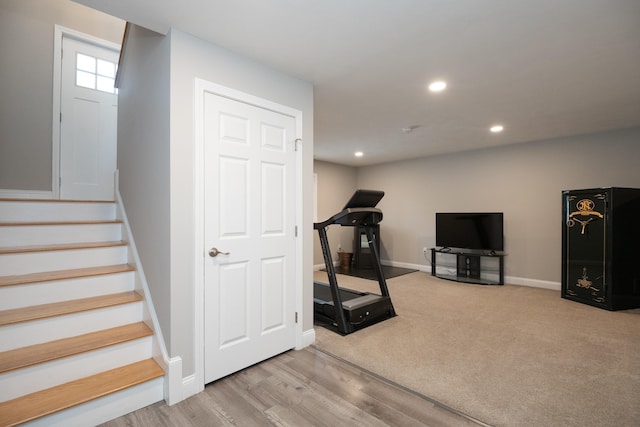 workout room with wood finished floors, recessed lighting, baseboards, and carpet floors