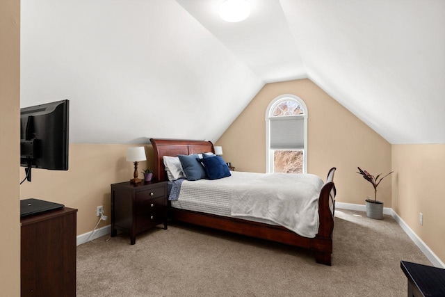 carpeted bedroom featuring vaulted ceiling and baseboards