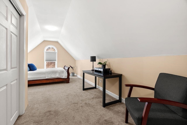 carpeted bedroom with baseboards and vaulted ceiling