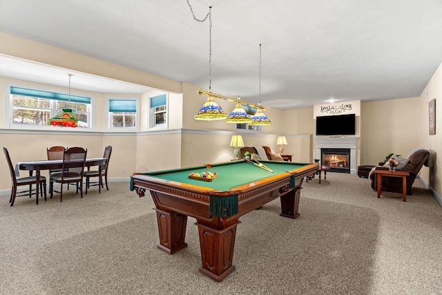 game room featuring baseboards, carpet, and a warm lit fireplace