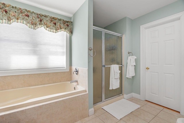 bathroom featuring tile patterned floors, a bath, and a shower stall