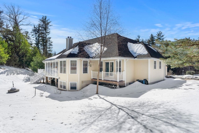 snow covered house with a chimney