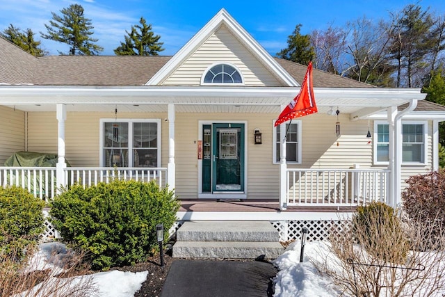 view of front of property with a porch and a shingled roof