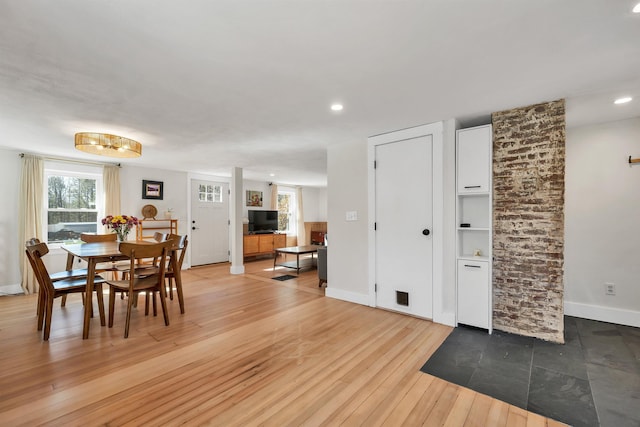 dining room with recessed lighting, light wood-type flooring, plenty of natural light, and baseboards