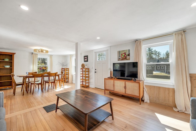 living area with light wood finished floors and recessed lighting