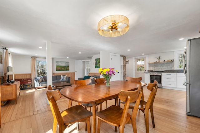 dining space featuring recessed lighting, a healthy amount of sunlight, and light wood finished floors