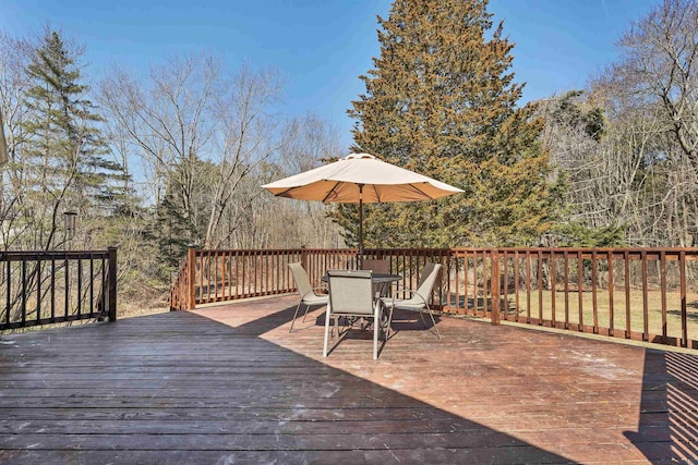 wooden terrace featuring outdoor dining space