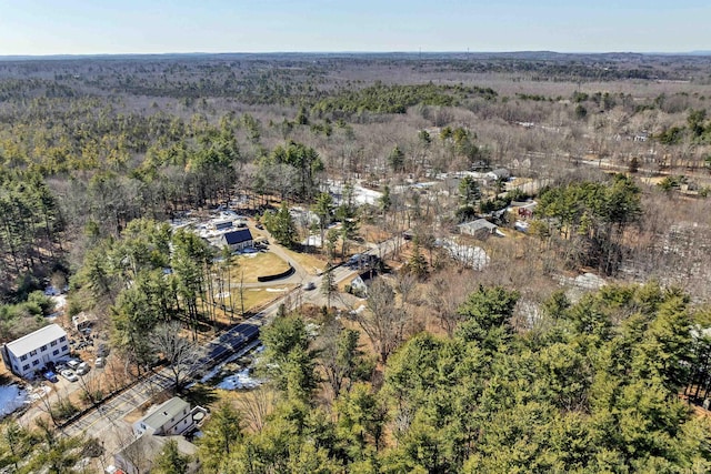 bird's eye view with a wooded view