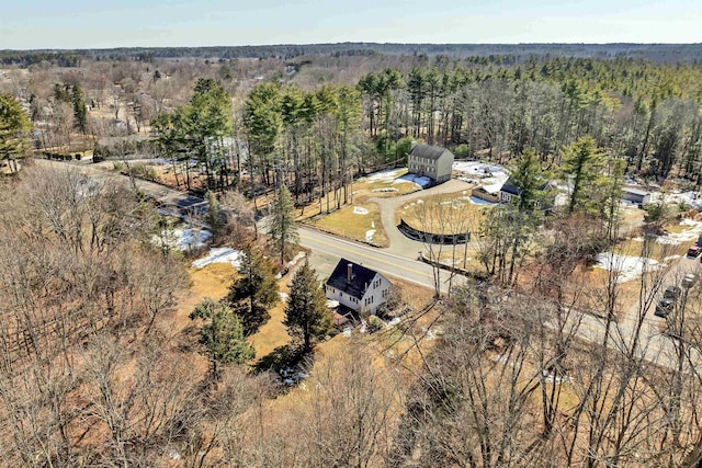 bird's eye view with a wooded view