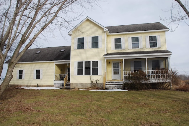 rear view of house with a porch, a lawn, and a shingled roof