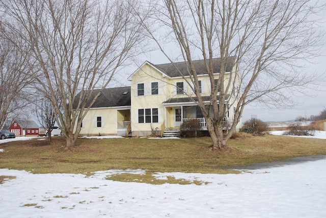 view of front facade featuring a lawn and a porch