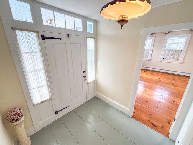 foyer featuring baseboards and a baseboard radiator