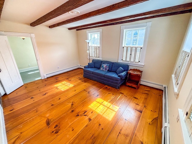 living room with beam ceiling, hardwood / wood-style flooring, baseboards, and a baseboard radiator