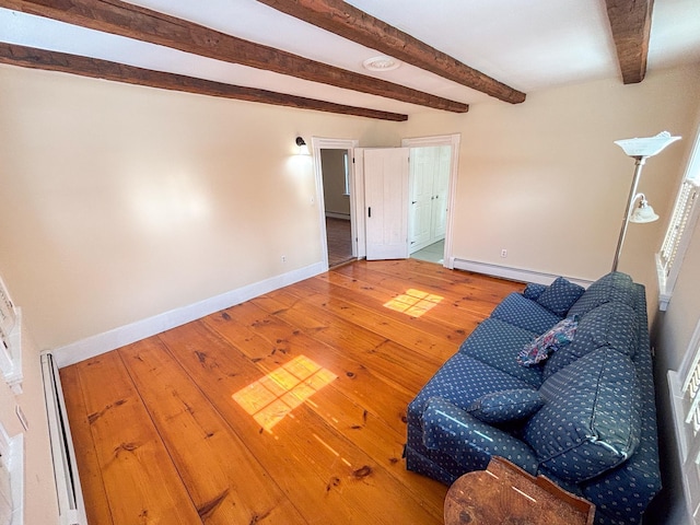 sitting room with a baseboard radiator, baseboards, beamed ceiling, and hardwood / wood-style floors