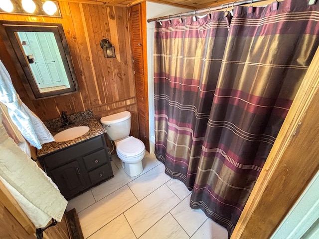 bathroom featuring wooden walls, curtained shower, toilet, and vanity