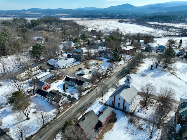 snowy aerial view with a mountain view